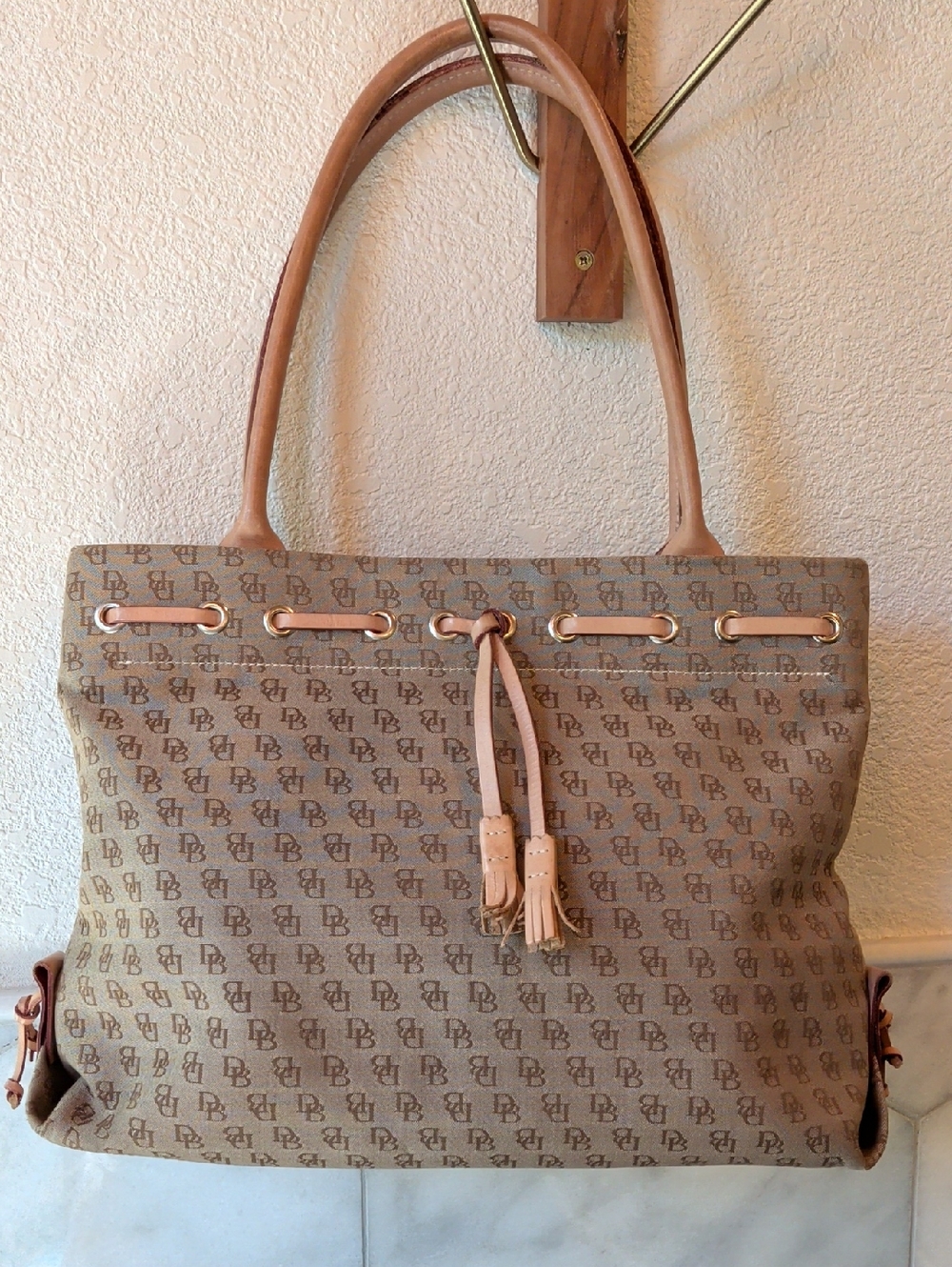 Dooney & Bourke Tan Monogram Canvas Tote with Tassel Detail